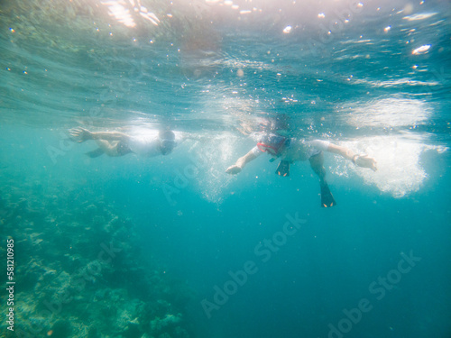 couple snorkeling in clear tropical sea © Melinda Nagy