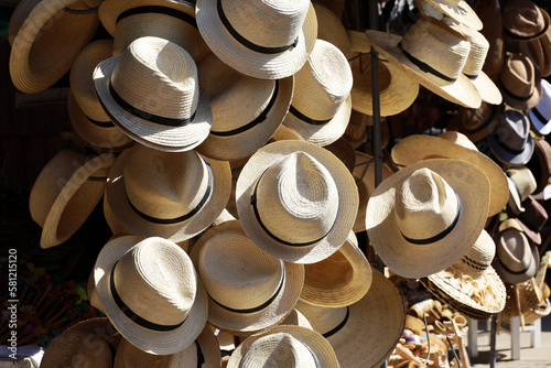 Sun hats in street market. Clothing and souvenirs for tourists on tropical resort