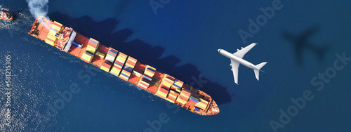 Obraz na płótnie Aerial drone ultra wide top down concept photo of container terminal and plane flying above indicating popular cargo means of transport w salonie