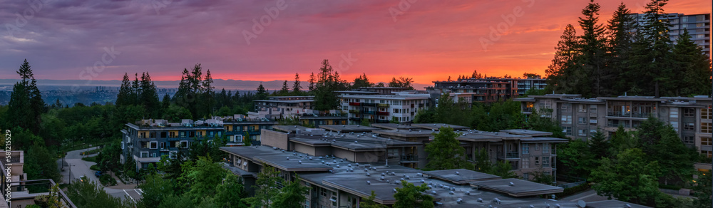 Stunning panoramic sunset over rooftops of homes in UniverCity Highlands, Burnaby, BC, as seen from a neighborhood patio.