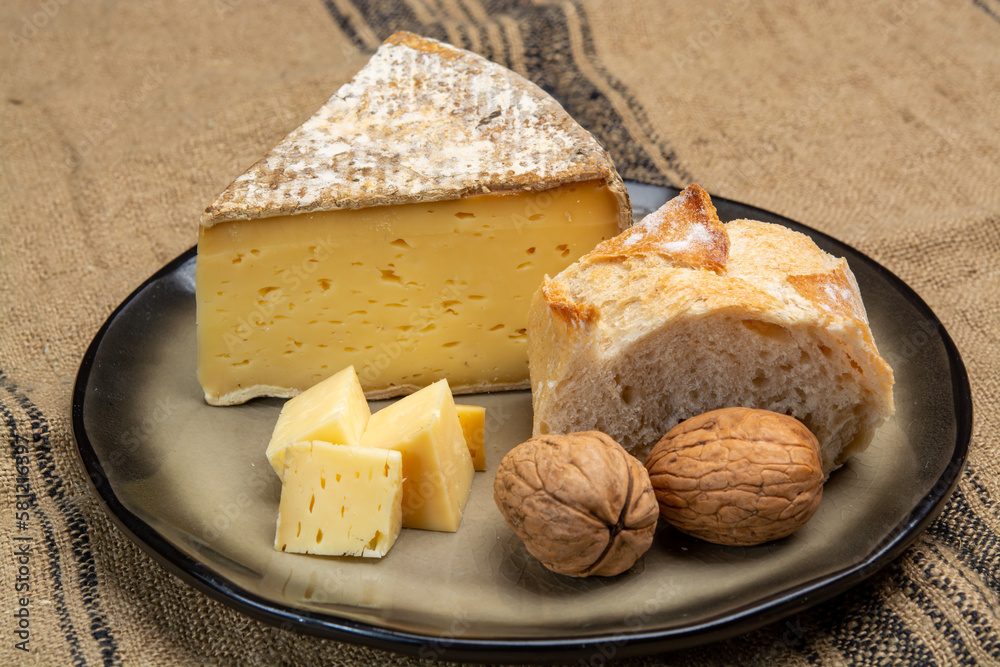 Pieces of cheese tomme de montagne or tomme de savoie made from cow milk in French Alps close up
