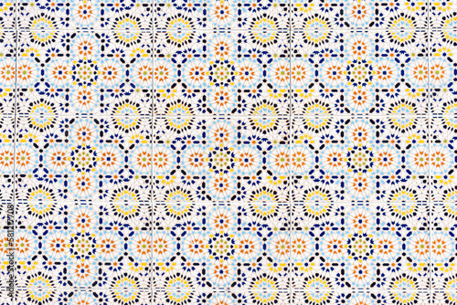 Old traditional ceramic azulejos tiles pattern on the house exterior. Abstract colorful floral geomtric background.