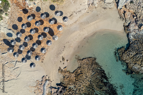 Drone aerial of beach umbrellas in the beach. Summer holidays in the sea.