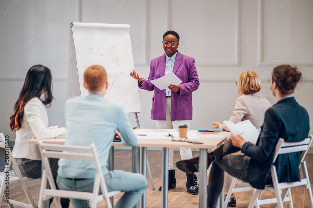 African american businesswoman holding a presentation during a meeting in an office African american businesswoman holding a presentation during a meeting in an office