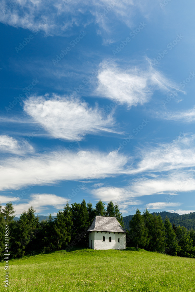 Tiny white hut under blue sky on the green hill in Pieniny mountains, Poland