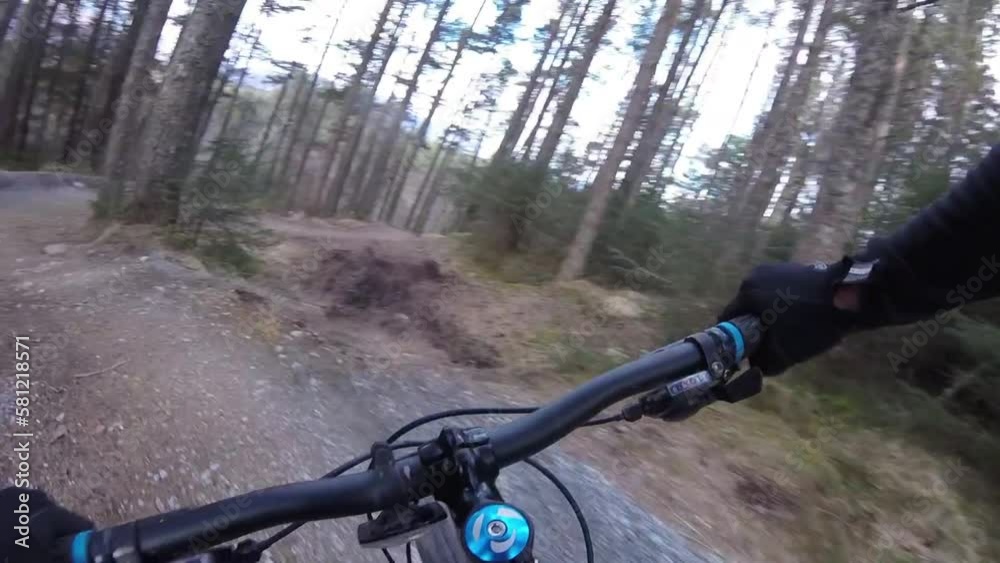 person riding a mountain bike on n a trail through the woods on twists and berms person riding a mountain bike on n a trail through the woods on twists and berms