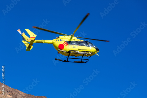 Emergency Medical Rescue helicopter in the sky over the Teide volcano, Tererife, Canary Islands, Spain