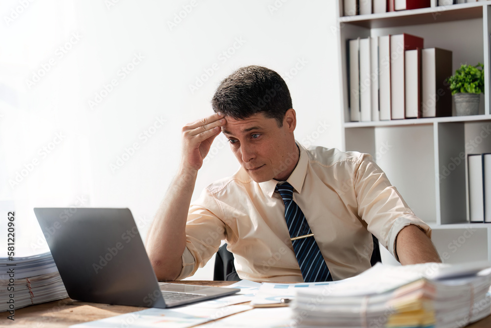 Serious businessman thinking hard of problem solution working in office with computers documents, thoughtful businessman focused on stock trading data analysis analyzing forecasting financial rates Serious businessman thinking hard of problem solution working in office with computers documents, thoughtful businessman focused on stock trading data analysis analyzing forecasting financial rates