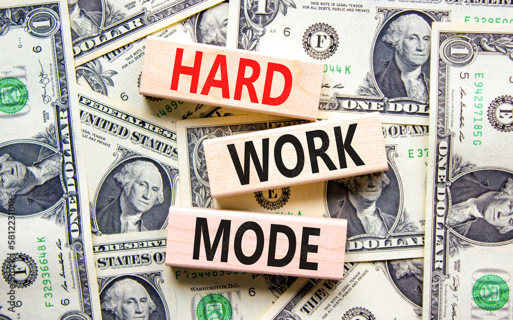 Hard work mode symbol. Concept words Hard work mode on wooden block on a beautiful background from dollar bills. Dollar bills. Business and Hard work mode concept. Copy space.
