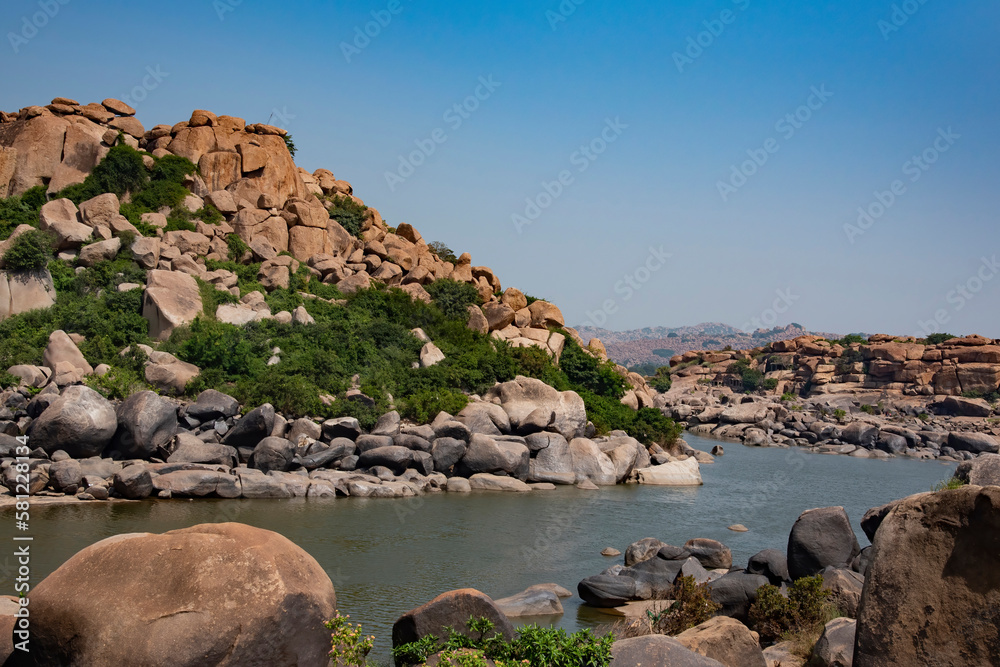 River Tungabhadra flowing through boulder strewn landscape of Hampi