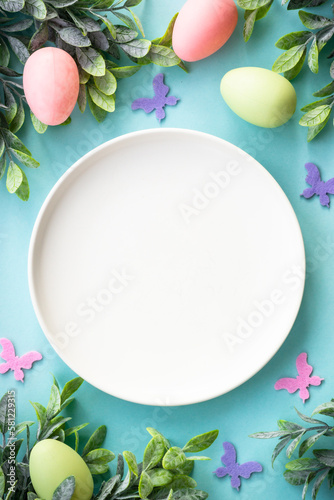 Easter table setting, Easter food background. White plate with eggs and holiday decorations.