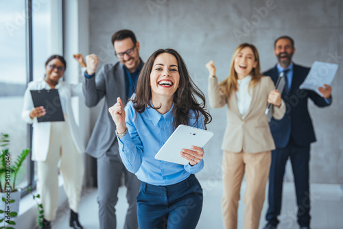 Excited happy multiracial businesspeople have fun engaged in activity in office together, overjoyed diverse colleagues dance celebrate successful business project, Friday celebration concept