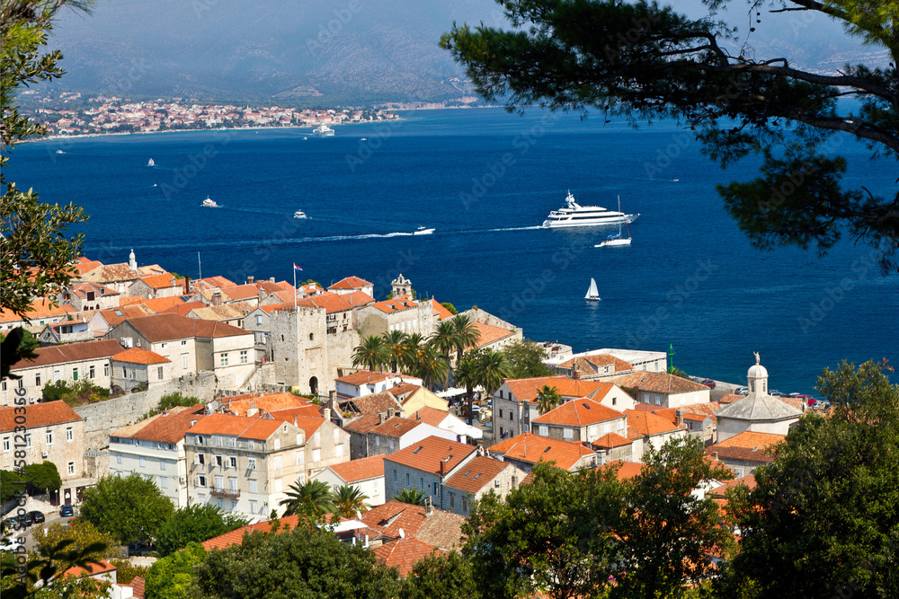View from above of the red-roofed buildings and harbor of Korcula, Croatia