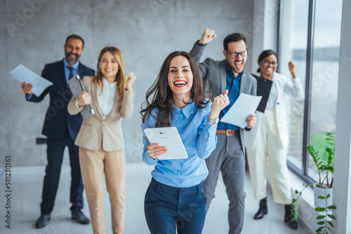 Excited happy multiracial businesspeople have fun engaged in activity in office together, overjoyed diverse colleagues dance celebrate successful business project, Friday celebration concept