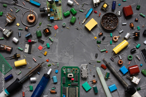 Different electronic components and equipment. flat lay with space for text on gray concrete background. set of spare parts DIY.