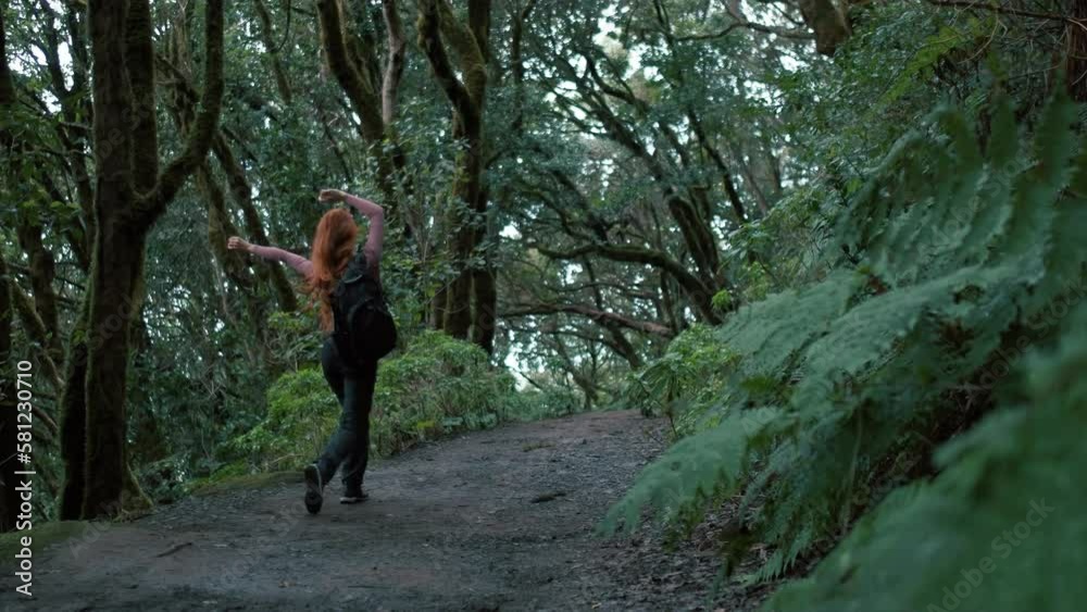 Woman is walking in an enchanted forest. Redhead girl with a long hair. Woman is walking in an enchanted forest. Redhead girl with a long hair.