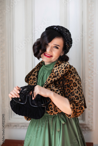 beautiful and happy brunette in retro clothes, beret and with a handbag. 