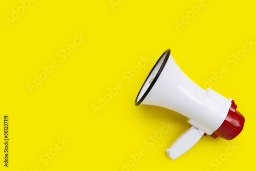 Red and white megaphone on yellow background.