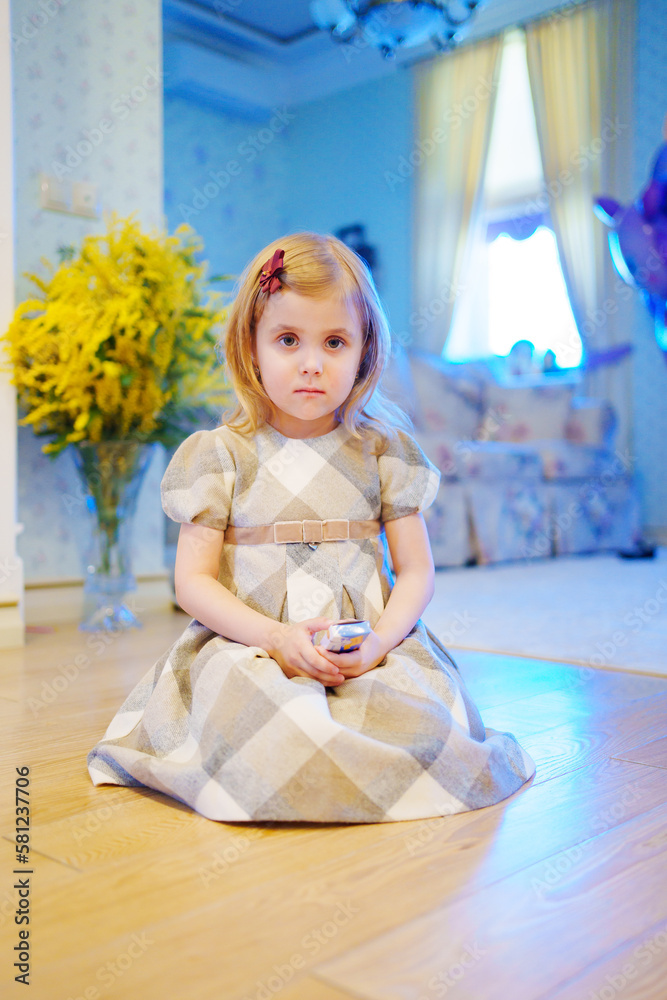 a portrait of a cute sad little girl in a plaid dress a portrait of a cute sad little girl in a plaid dress