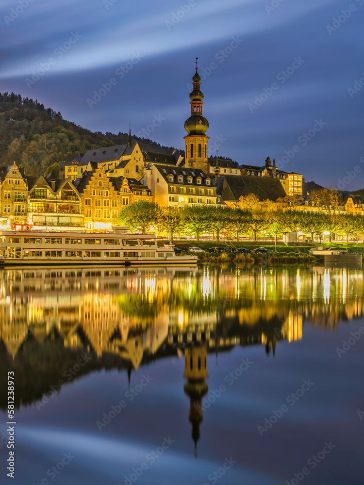 Cochem riverside buildings lit up after sunset and lights reflection on Moselle river in Cochem-Zell district in Rhineland-Palatinate, Germany