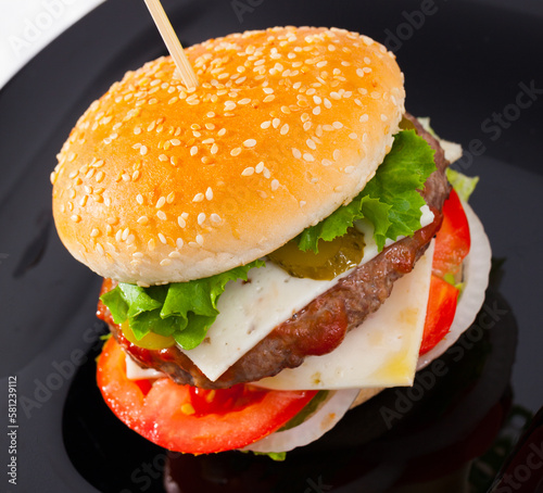 Hamburger is tasty dish on the plate in the kitchen of restaurante. photo