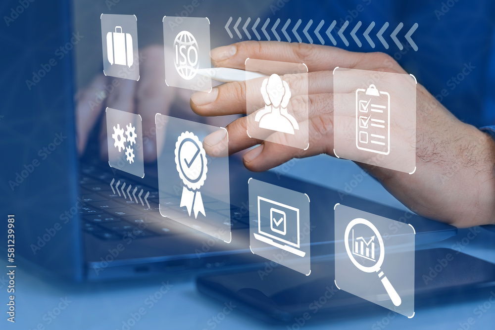 Businessman works on laptop with marks of highest quality of service ...