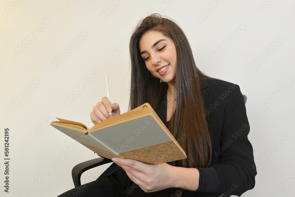woman writing and reading a book woman writing and reading a book