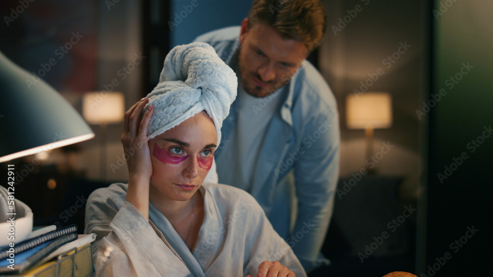 Obraz premium Angry woman trying concentrate at home. Annoying man vacuuming disturbing wife