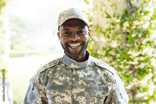 Portrait of happy african american male soldier looking at camera and smiling