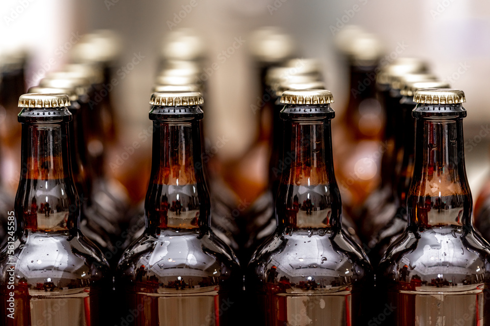 dewy bottles of beer in a row in a warehouse ready for export