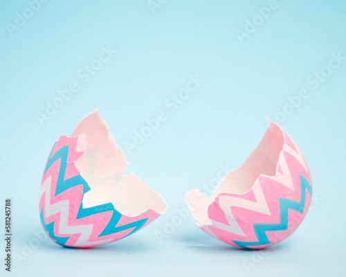 Pink and blue Easter egg open and cracked in half. Empty copy space for text or product.