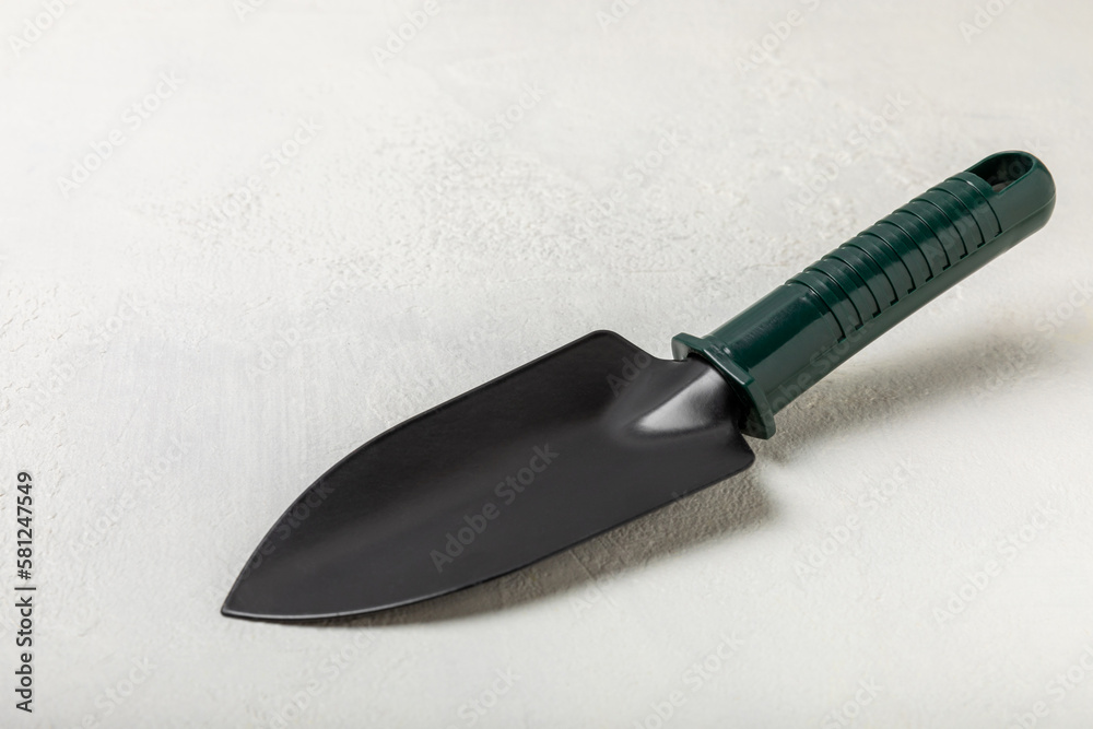 Garden tools on the background of a concrete table. Garden shovels. Top view. Flat lay. Concept of gardening or planting. Work in the spring garden.
