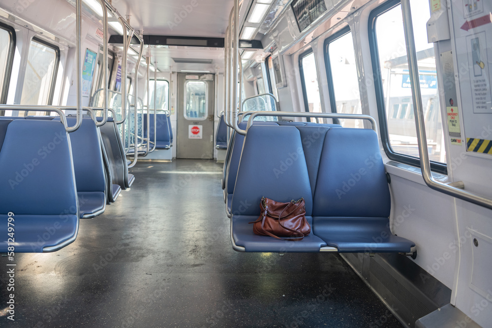 A bag left on a seat in a subway car.
