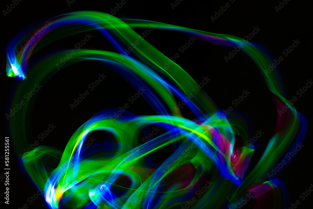 Abstract light shapes on dark background without the use of photoshop. Light effects generate a light painting photography.