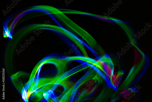 Abstract light shapes on dark background without the use of photoshop. Light effects generate a light painting photography.
