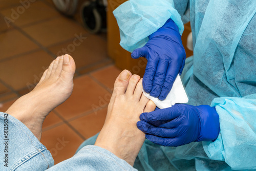 Podiatrist carefully cleans your patient's toenails to begin the medical pedicure. High quality photo