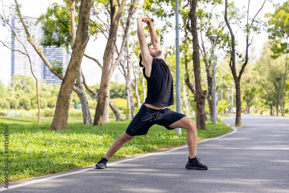 Caucasian man in sportswear stretching body and warm up before jogging exercise at public park in the morning. Healthy guy athlete enjoy outdoor lifestyle sport training running workout in the city. Caucasian man in sportswear stretching body and warm up before jogging exercise at public park in the morning. Healthy guy athlete enjoy outdoor lifestyle sport training running workout in the city.