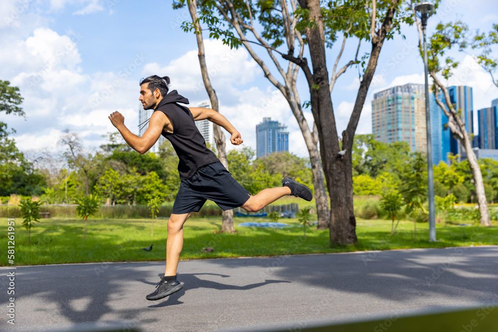Handsome Caucasian man jogger in sportswear jogging exercise at public park in summer morning. Healthy guy athlete enjoy outdoor activity lifestyle sport training fitness running workout in the city.