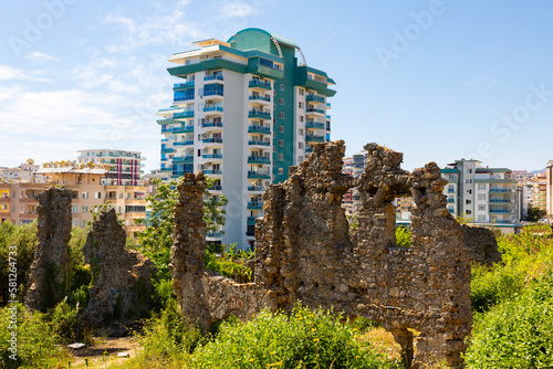 Naula Ancient City ruins among modern buildings of Mahmutlar, district of Alanya, Turkey. photo