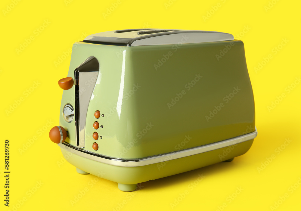 Modern toaster on yellow background Modern toaster on yellow background