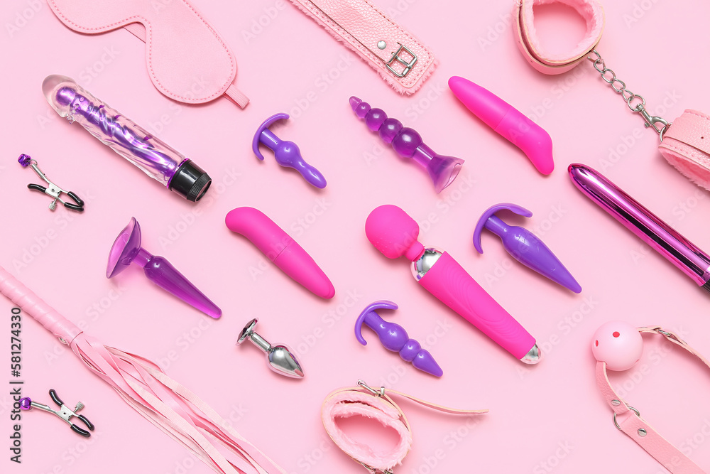 Different sex toys on pink background