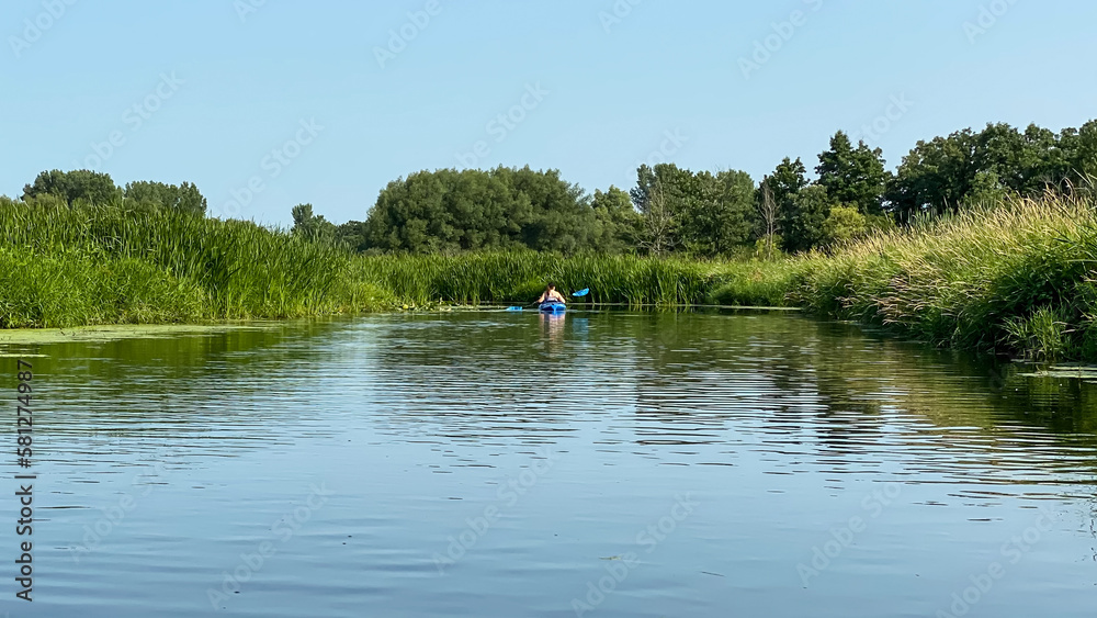 woman kayaking the lake during summer