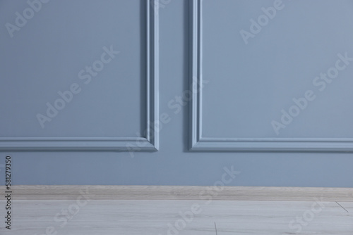 Beautiful light blue wall with molding in clean empty room