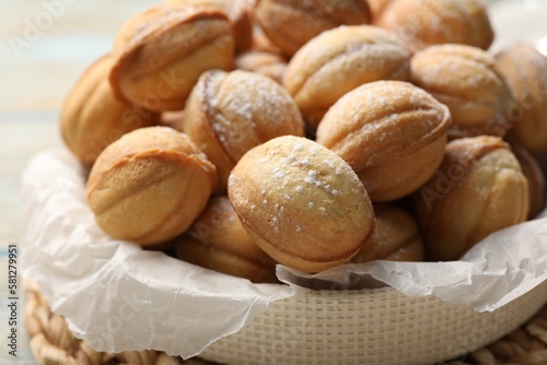 Bowl of delicious nut shaped cookies on grey wooden table, closeup