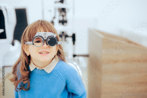 Little Girl Wearing Trial Glasses in Eye Examination Consult Appointment. Child during pediatric ophthalmological consultation in eye clinic 