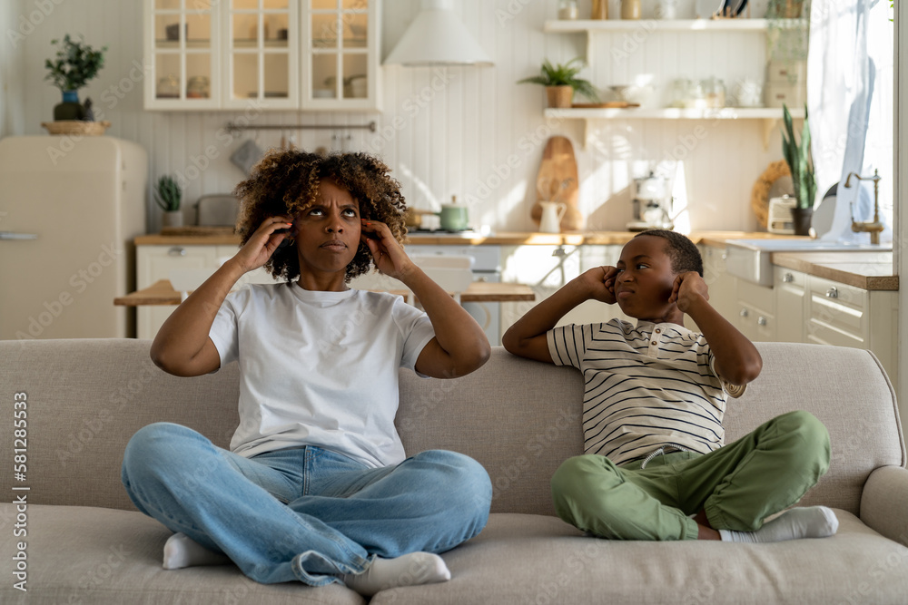 Foto de Unhappy irritated African American family mother and son