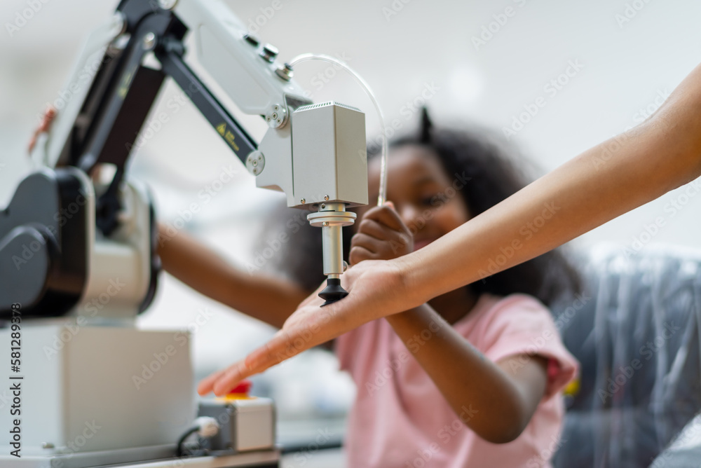 Kid female teen child enjoy Machine Learning Robot arm is Moving Under Control robot at technology class, stem education robot arms for digital automation software for artificial intelligence ai Kid female teen child enjoy Machine Learning Robot arm is Moving Under Control robot at technology class, stem education robot arms for digital automation software for artificial intelligence ai