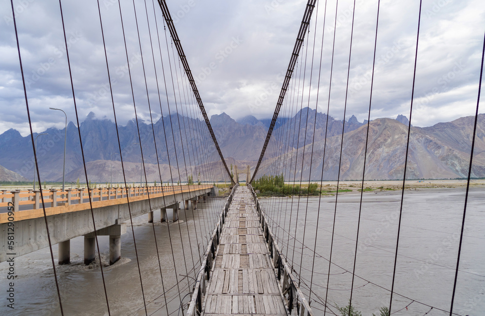 Obraz premium A bridge in Karakoram high mountain hills. Nature landscape background, Skardu-Gilgit, Pakistan. Travel on holiday vacation.