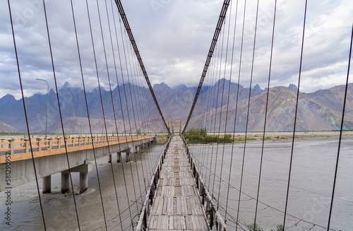 A bridge in Karakoram high mountain hills. Nature landscape background, Skardu-Gilgit, Pakistan. Travel on holiday vacation. © tampatra