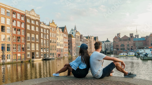 Photography Amsterdam Damrak during sunset, happy couple man and woman on a summer evening a